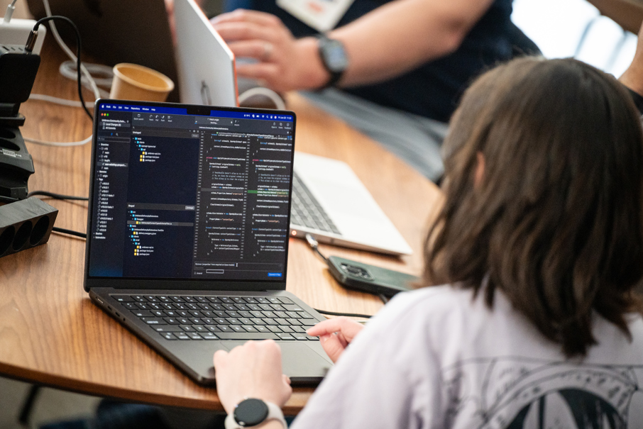 Woman sitting in front of computer coding